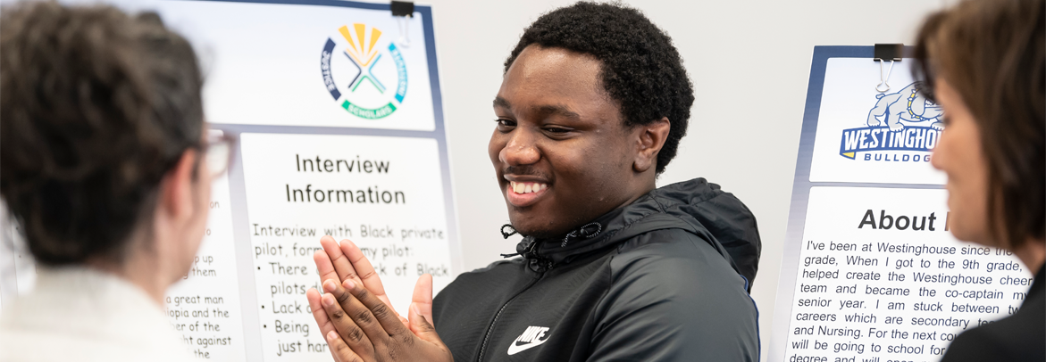 A student smiling at his presentation